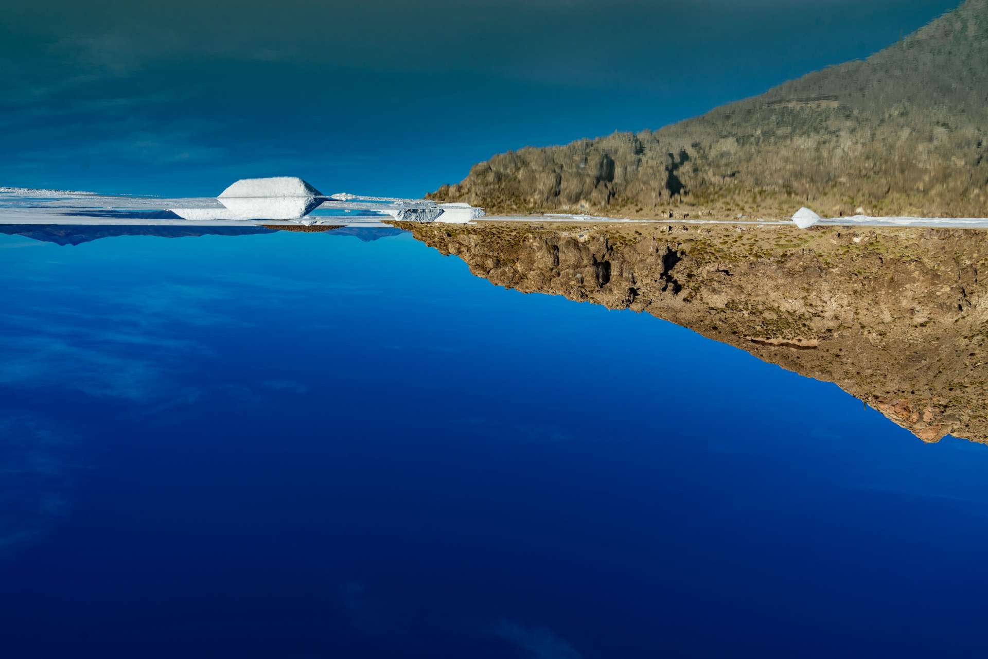 Salar de Uyuni Bolivia world largest salt flat aerial view mirroring effect