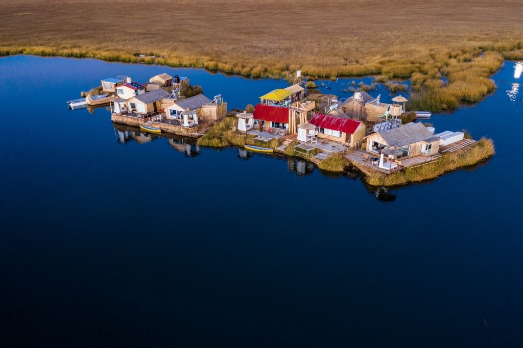 Uros Floating Islands Titicaca Lake Puno Peru aerial drone shot lodge