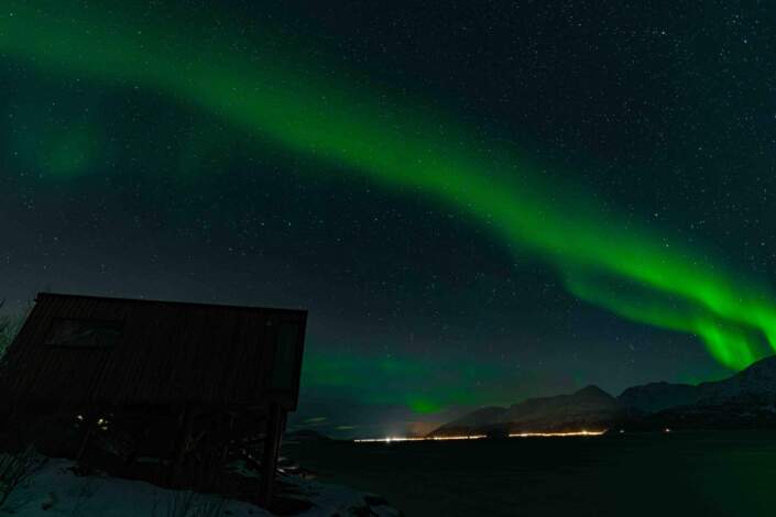 northern lights aurora fjord cabins