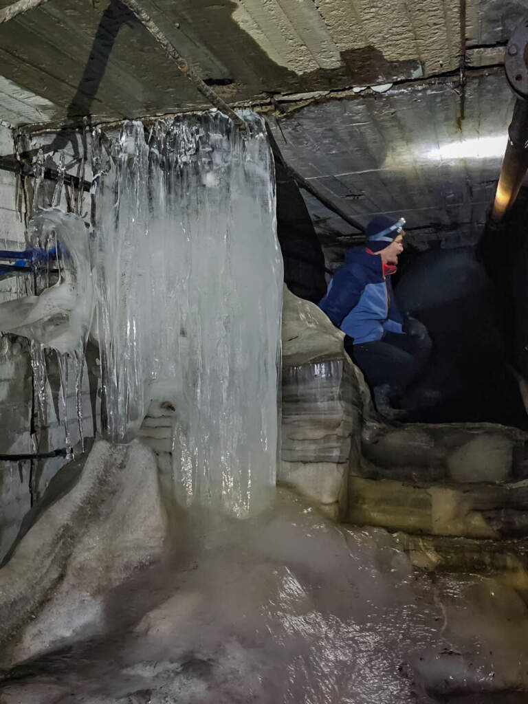 entering pyramiden coal mine through a wall of ice